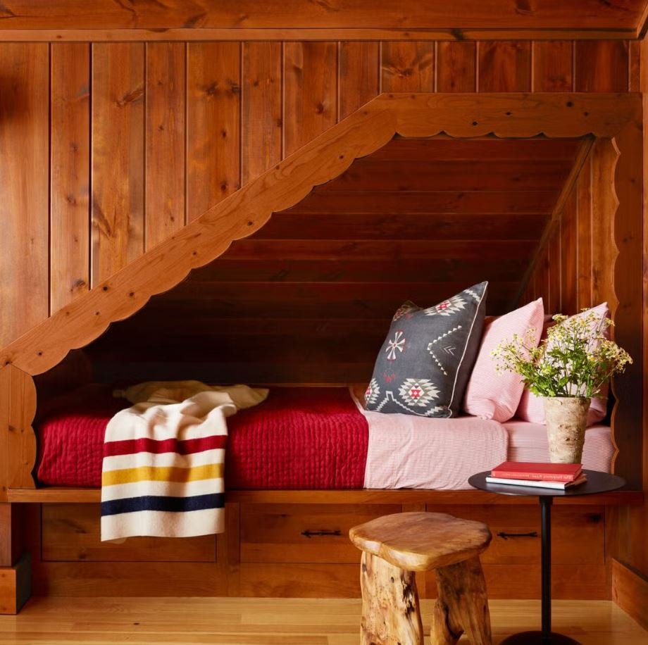 Cozy reading corner with cushions and soft lighting in a dorm room