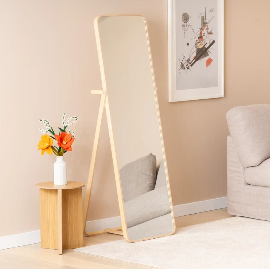 Full-length mirror making a small dorm room feel larger
